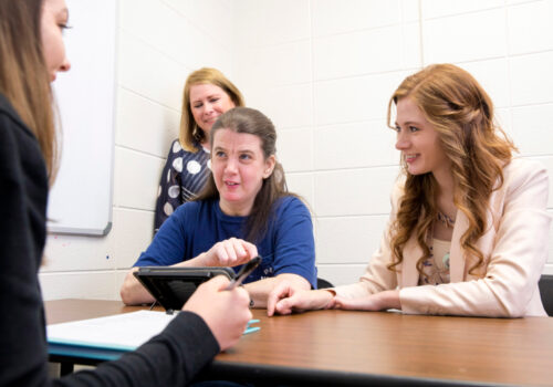 (L-R) Jenna Freeman (Communication Sciences and Disorders graduate student), Nancy Dellaria (Clinical Associate Professor), patient Jennie Cordell, and Alexandra Clanton (Communication Sciences and Disorders graduate student) practice communications skills during a therapy session in the Speech and Hearing Clinic .