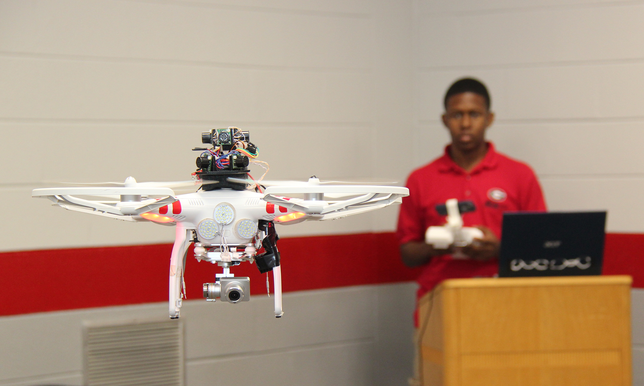 student flying drone