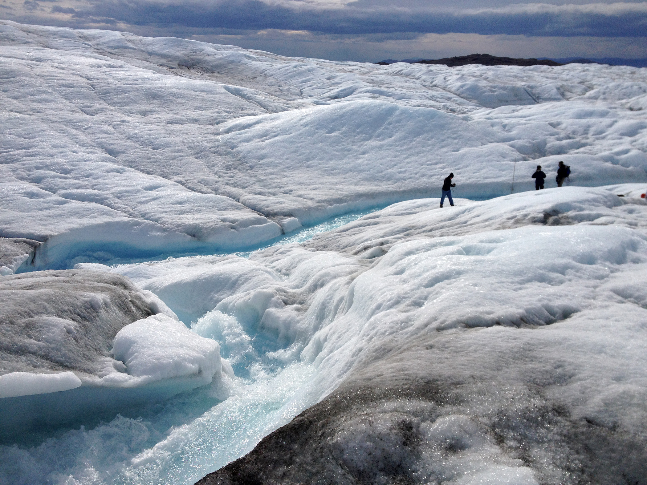 researchers in Greenland observing melt water
