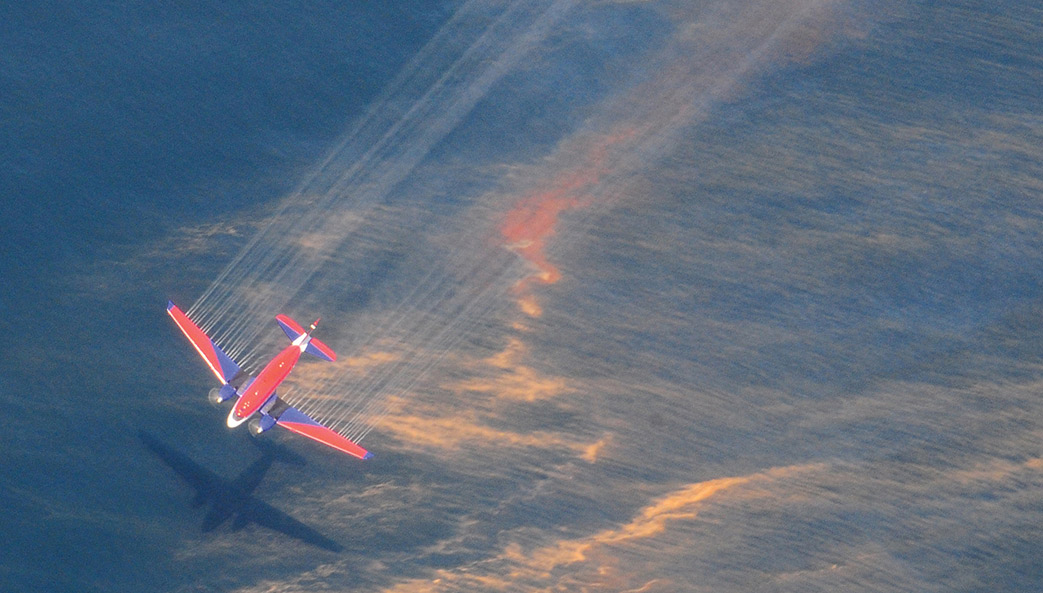 An airplane releases chemical dispersants over an oil slick in the Gulf of Mexico in 2010