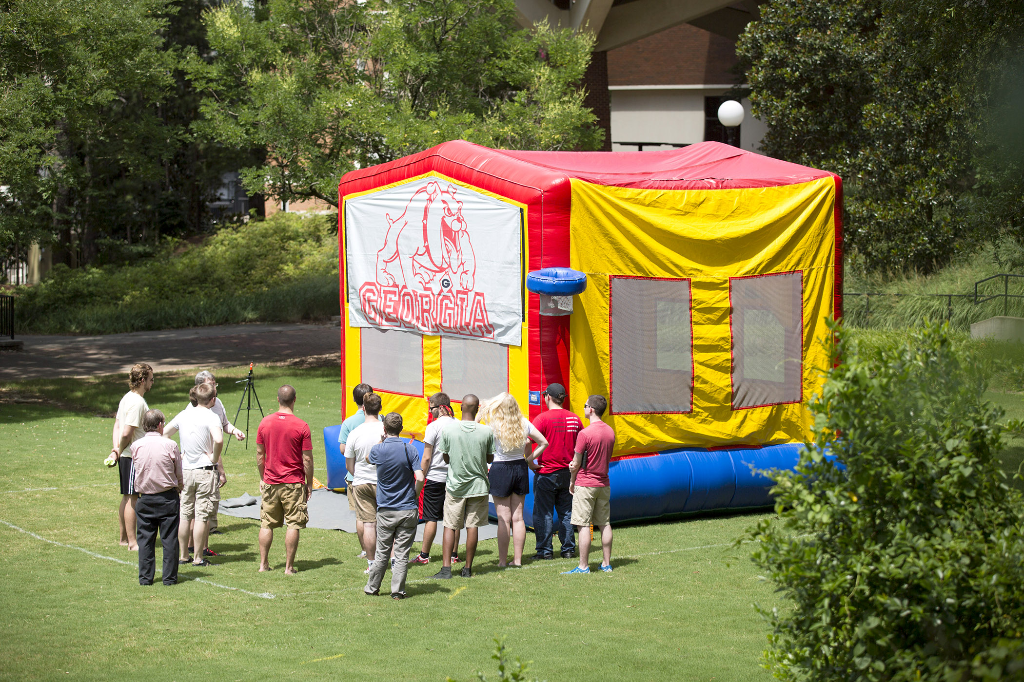 Researchers stand next to an inflatable bounce house