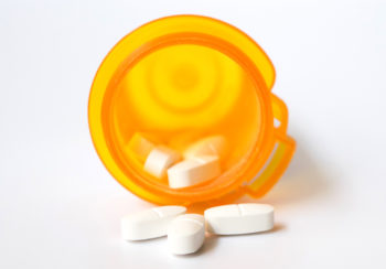 pill spilling out of a prescription bottle