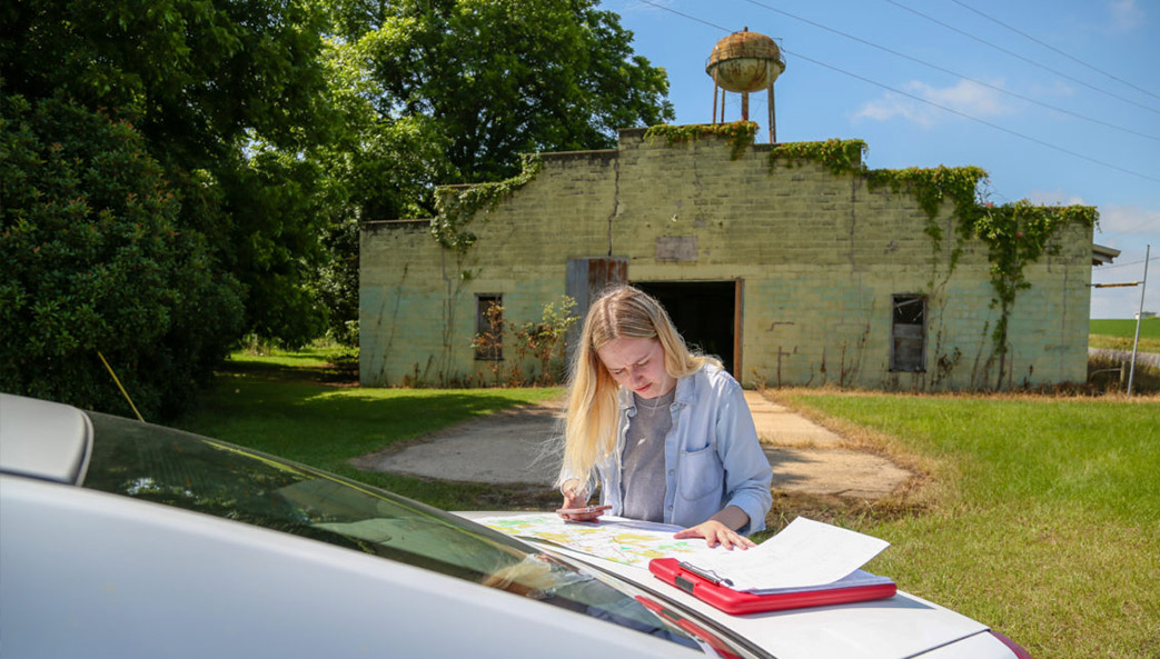 Student Anders Yount looks for properties that are at least 40 years old in Dooly County, Georgia, as part of a University of Georgia service-learning project