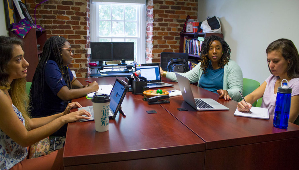 Tiffany Washington, assistant professor, University of Georgia School of Social Work, discusses research methods used in gerontology with graduate students who are assisting with a study of caregiver respite.