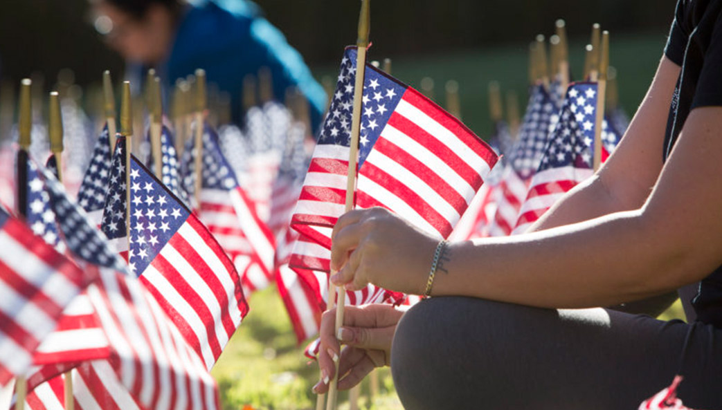 Students place flags in UGA's Memorial Garden. (Photo by Peter Frey/UGA)