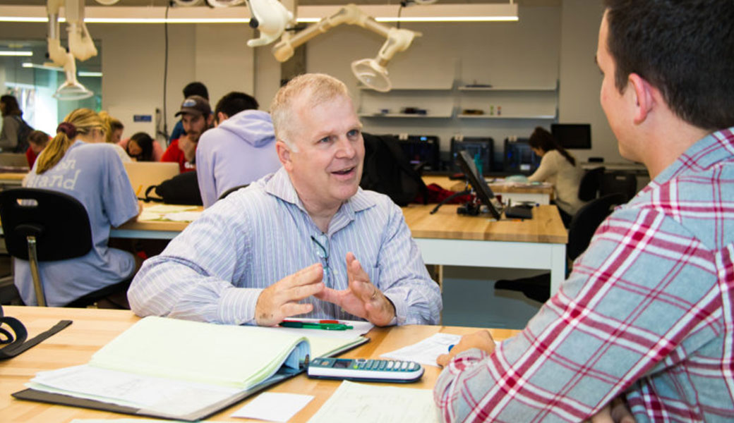 Peter Carnell, a professor of practice in the UGA College of Engineering, meets with students during an open study session in the Driftmier Engineering Center.