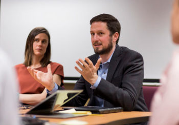 Joachim Walther talks with students during a research group meeting.