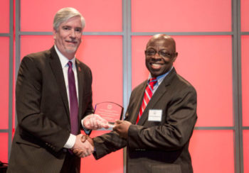Valentine Nzengung, right, receives the Academic Entrepreneur of the Year Award in 2016 from Derek Eberhart, associate vice president for research.