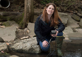 image of UGA ecologist Krista Capps in a creek