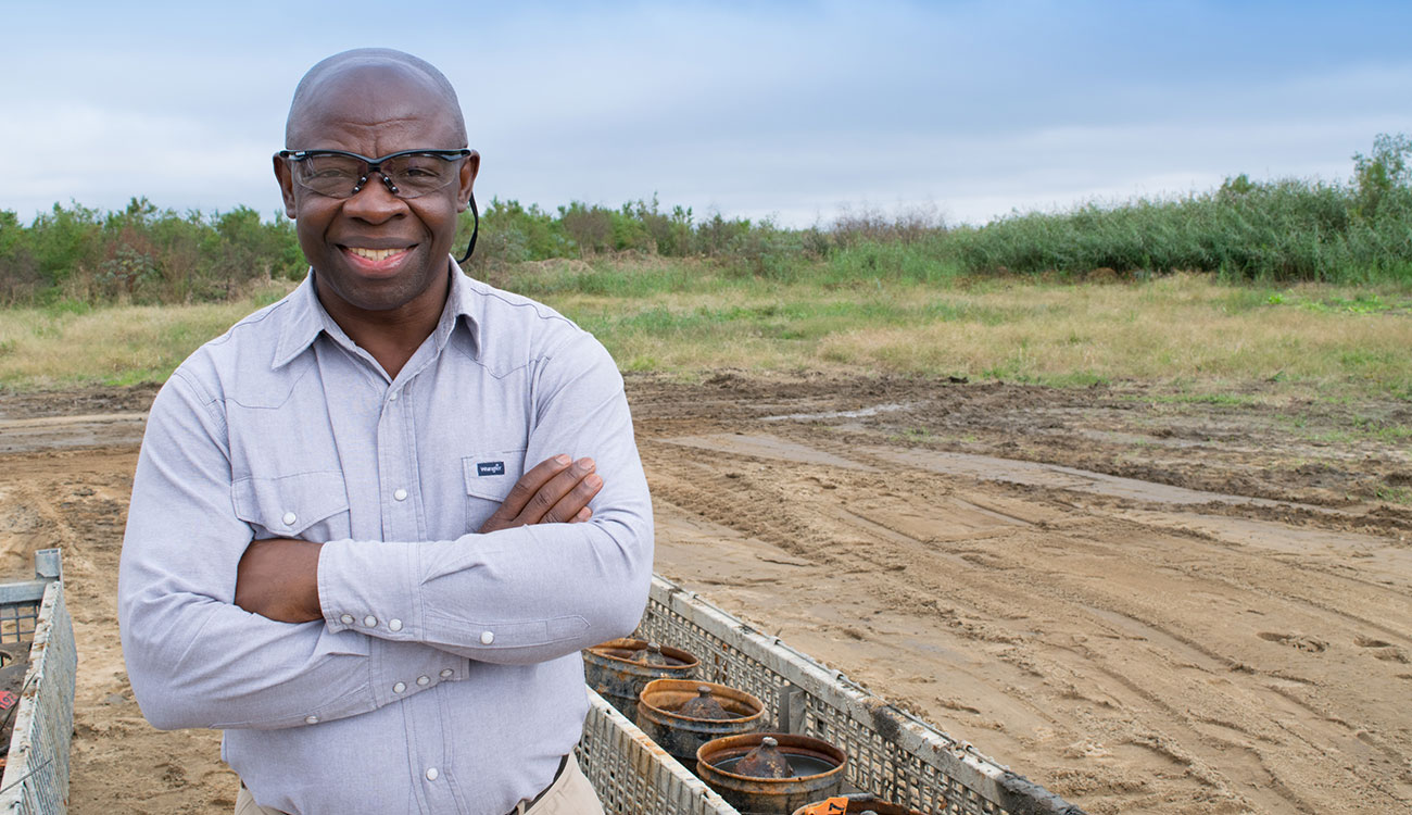 University of Georgia researcher Valentine Nzengung poses for a photo at the site of a munitions remediation facility