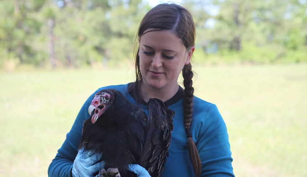 photo of Amanda Holland holding a turkey vulture