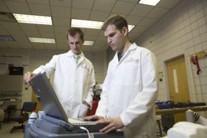 image of professor Murrow in lab with student