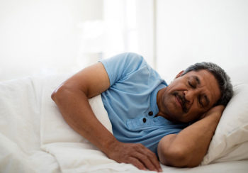 photo of older man sleeping in bed