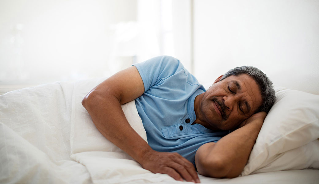photo of older man sleeping in bed