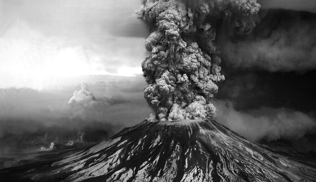 An ash plume billows from the crater atop Mount St. Helens hours after its eruption began on May 18th, 1980, in Washington State. The column of ash and gas reached 15 miles into the atmosphere, depositing ash across a dozen states.