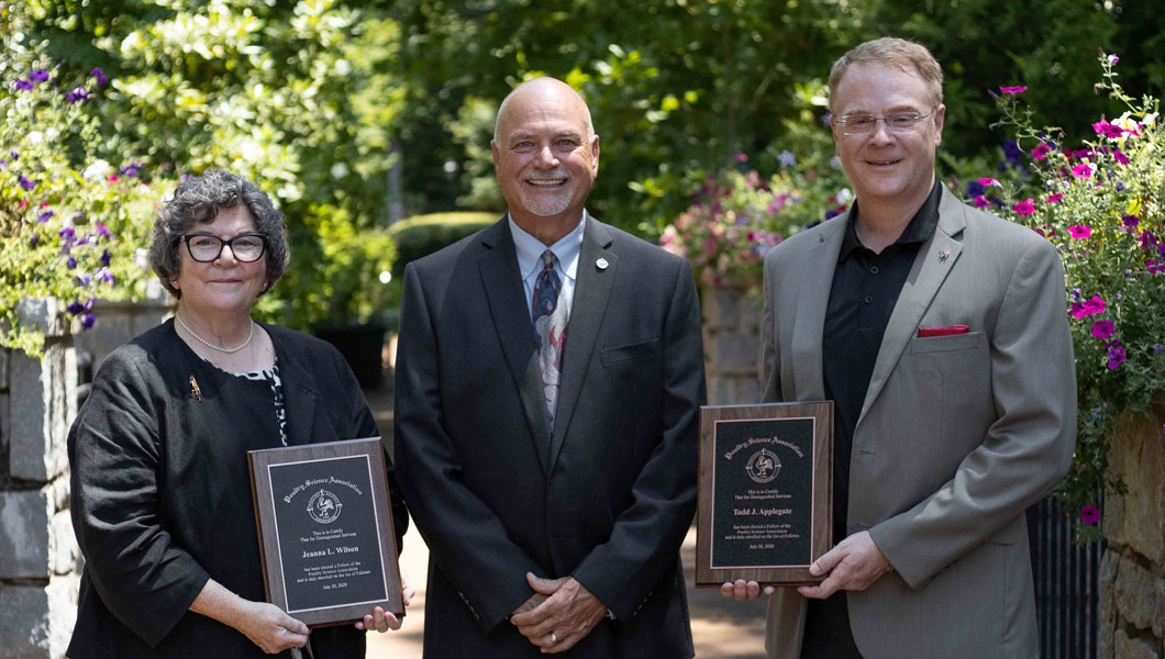 Photo of Wilson and Applegate receving their awards from Poultry Science Association President Don McIntyre
