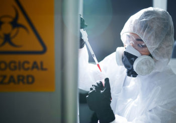 photo of person in hazmat suit in a lab