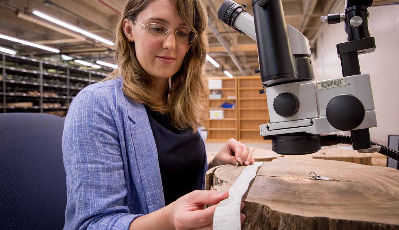 University of Georgia graduate student Kat Napora works with tree sample at microscope