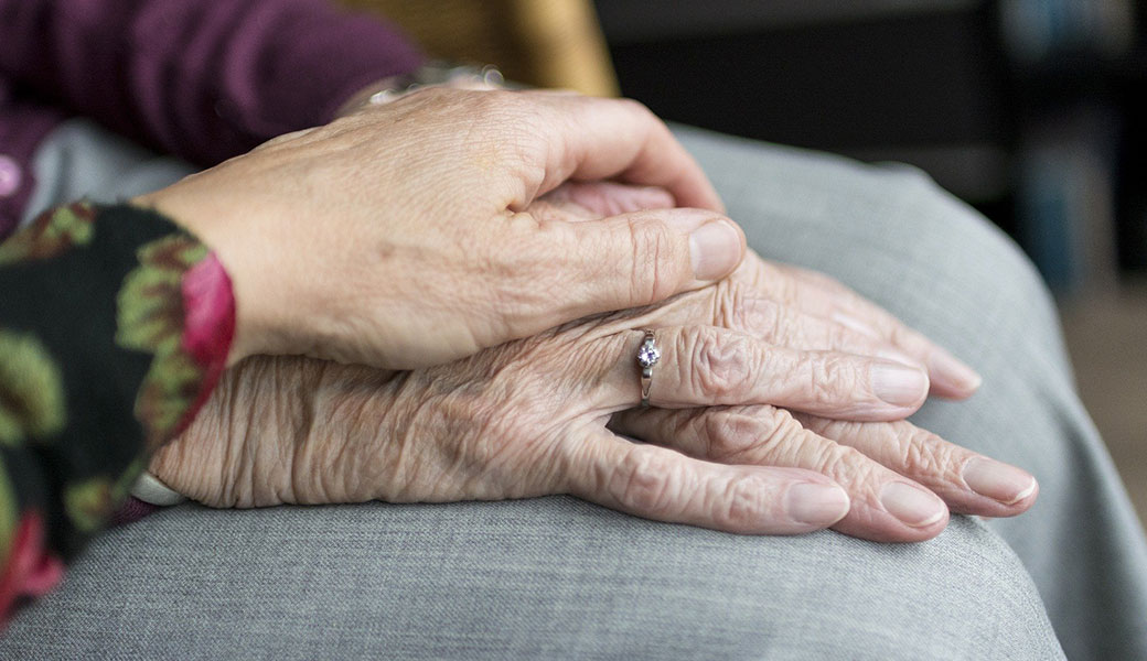 photo of elderly couple holding hands