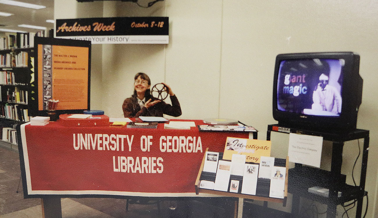 woman hosting informational booth in library
