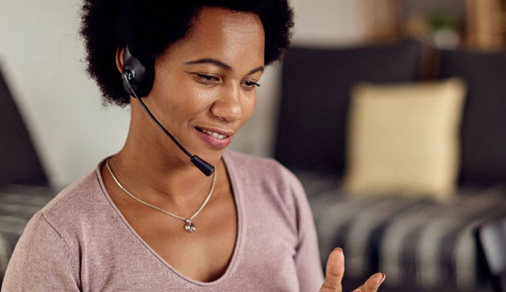 photo of woman with headset on talking