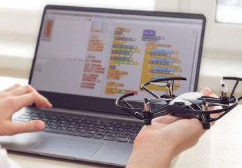 photo of a student studying drones on a laptop