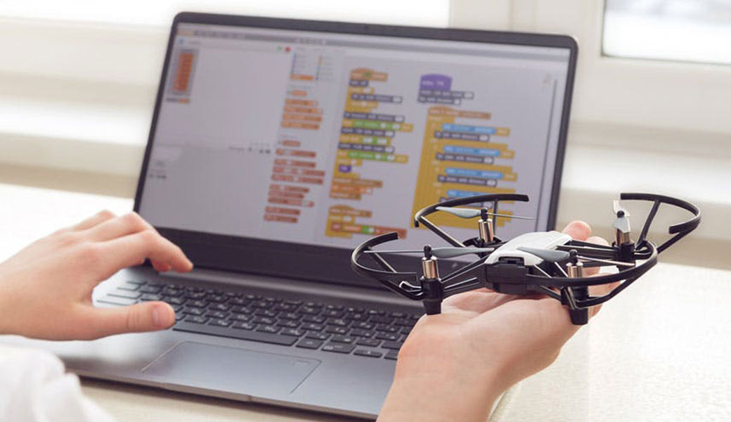 photo of a student studying drones on a laptop