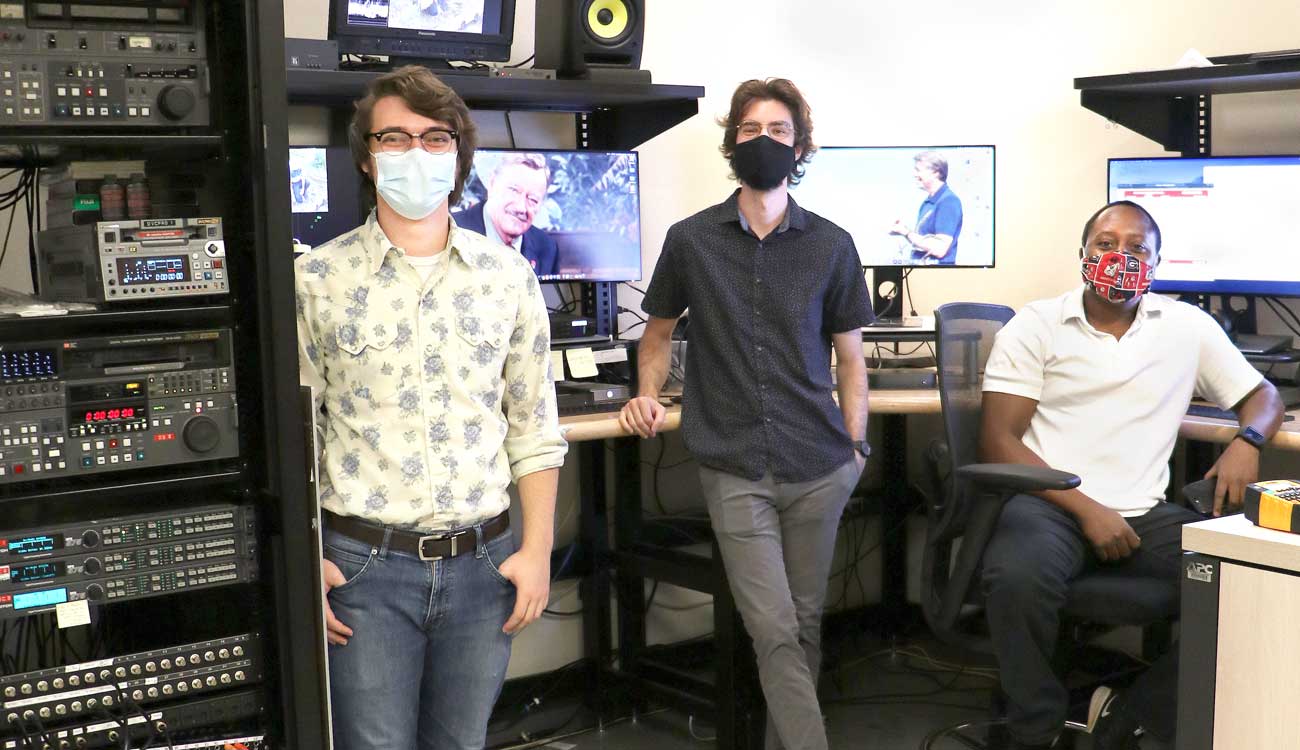 three audiovisual technicians at their work station