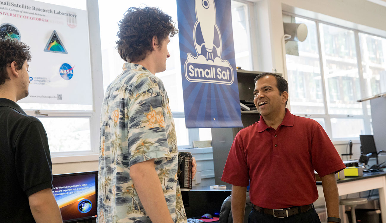 Deepak Mishra (R) talking to students in the Small Satellite Research Laboratory (SSRL).