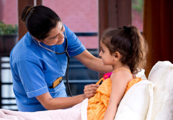 photo of nurse checking on a child