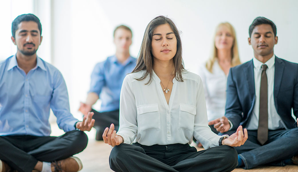 people meditating in business attire
