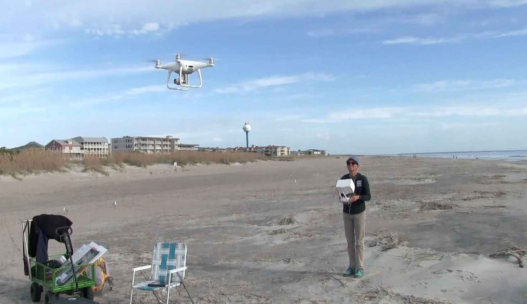person operating drone on beach