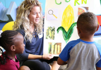 photo of a daycare worker talking to children