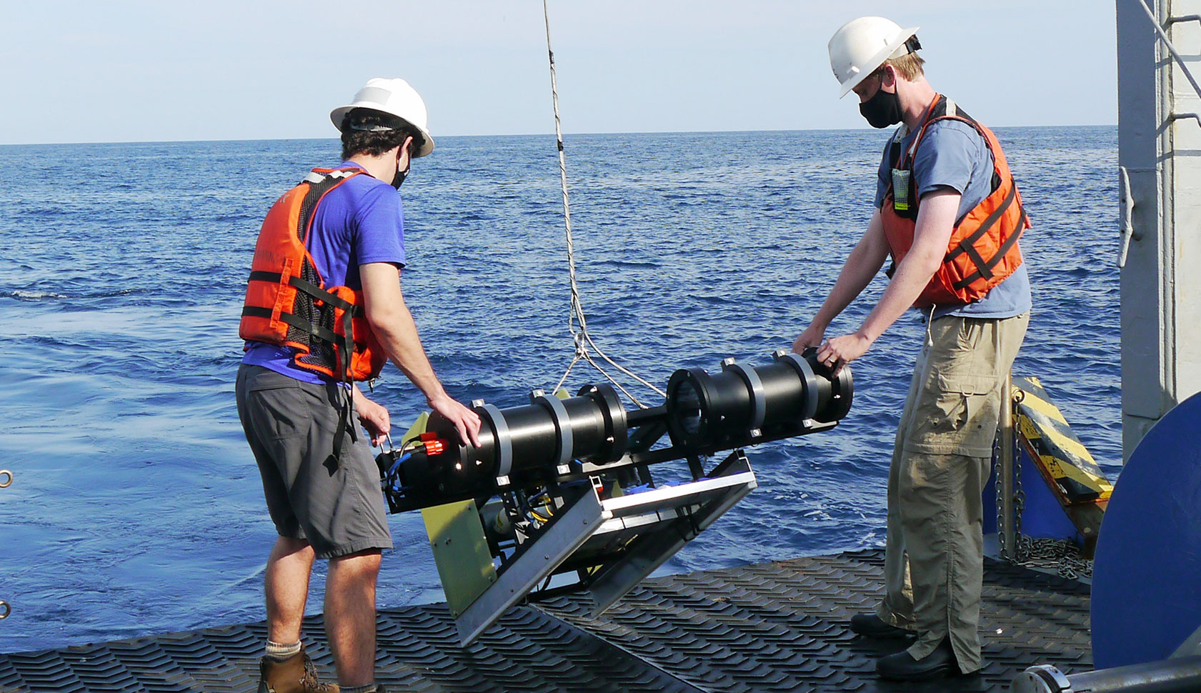 UGA grad student Kyle Aaron (left) and Skidaway researcher Adam Greer prepare to deploy a plankton imaging system.