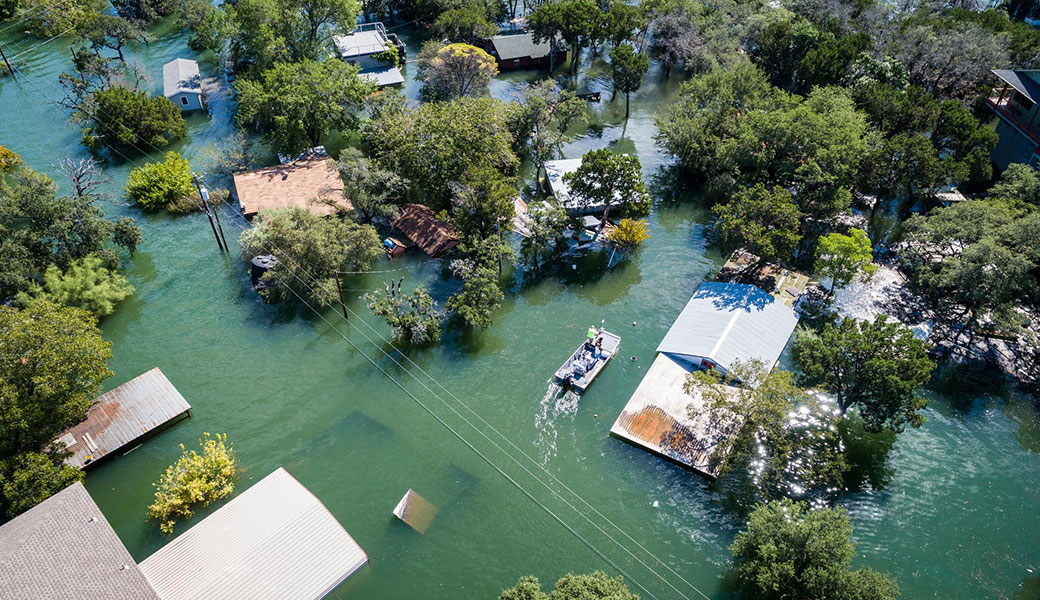 aerial photo of a flooded street and homes