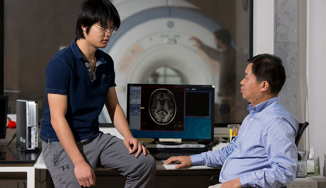 University of Georgia researcher Tianming Liu works in MRI lab with student