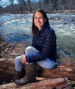 University of Georgia researcher Erin Lipp sitting by river