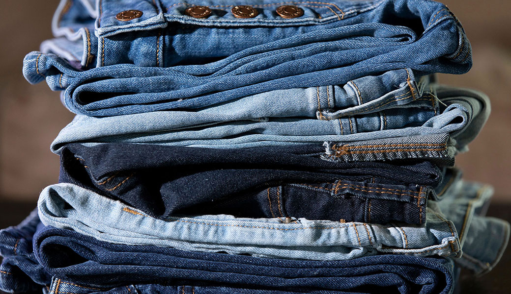 stack of folded blue jeans