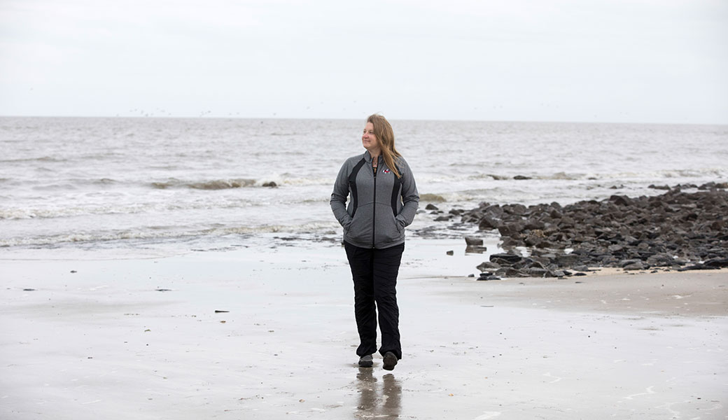 University of Georgia researcher Jenna Jambeck walking on a beach