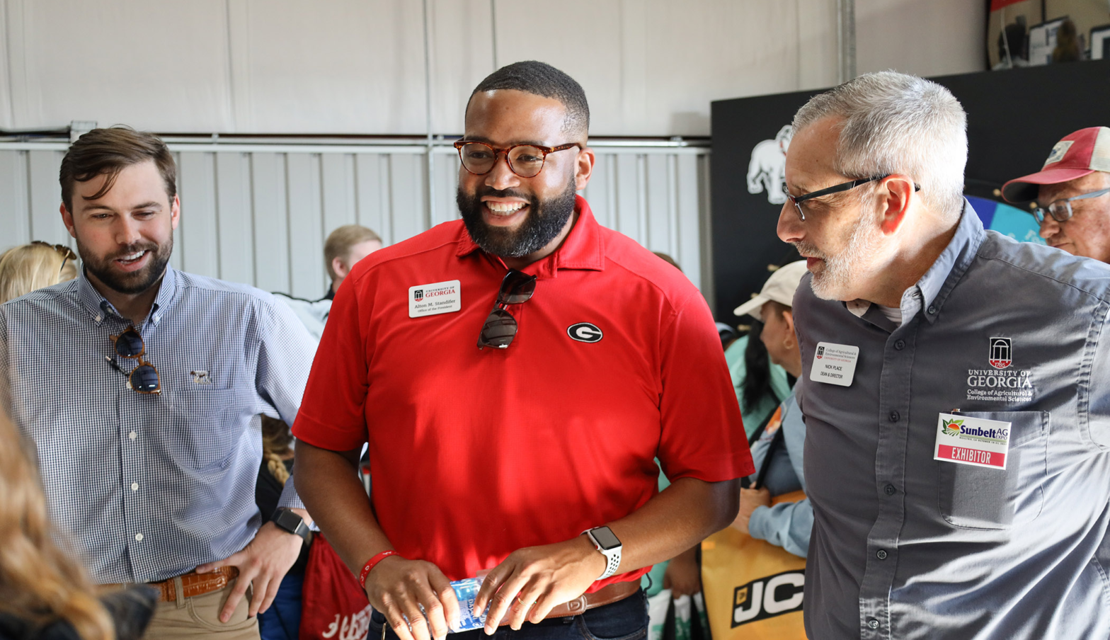 From left, Blake Raulerson, Alton Standifer and Nick Place talk with CAES Ambassadors at the Sunbelt Ag Expo in Moultrie, Georgia.