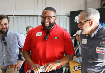 From left, Blake Raulerson, Alton Standifer and Nick Place talk with CAES Ambassadors at the Sunbelt Ag Expo in Moultrie, Georgia.
