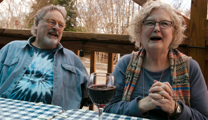 man and woman sitting at picnic table