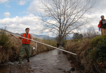 UGA professor Rhett Jackson (left) takes a sample from a creek in Macon County, North Carolina