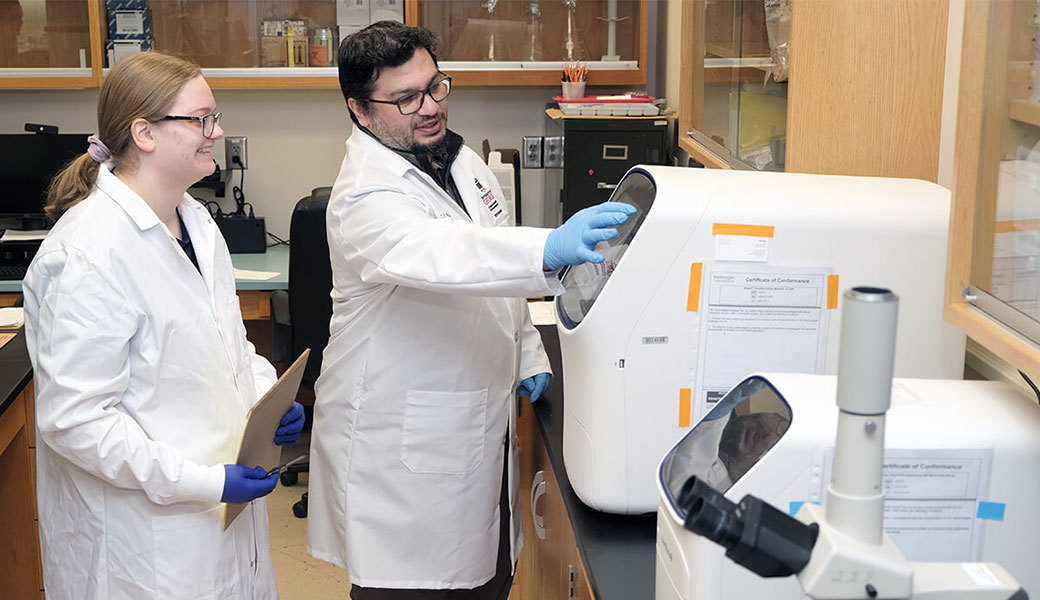 UGA researcher Issmat Kassem, pictured to the right of research professional Miranda Barr in laboratory
