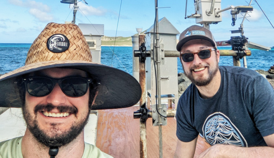 Clifton Buck (l) and Daniel Ohnemus (r) pose in front of their collection equipment on the Makai Research Pier.