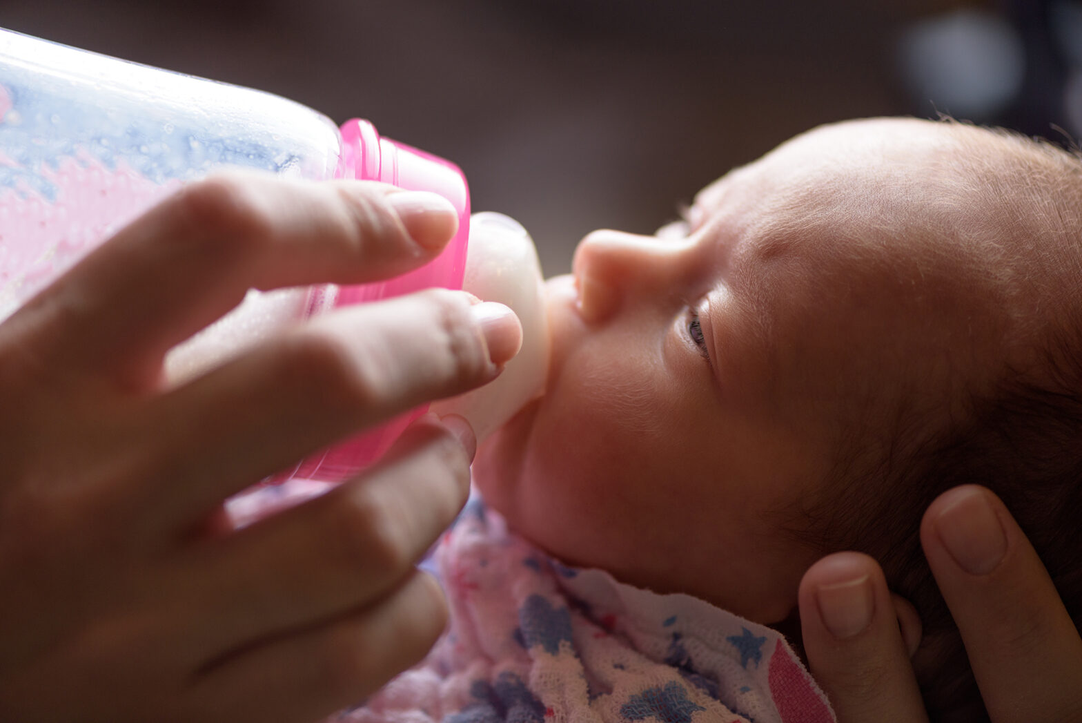 Infant taking milk from a bottle