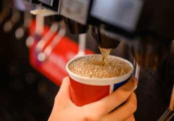 Filling up a cup of soda at the soda machine