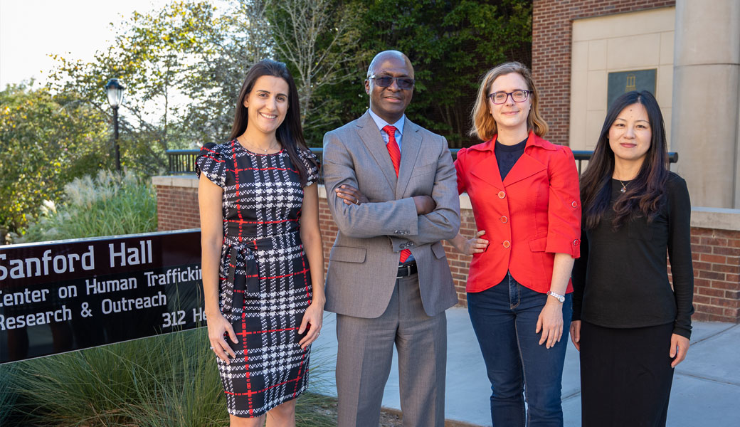 Researchers on labor trafficking in southern Africa standing in front of Sanford Hall on the University of Georgia's campus.