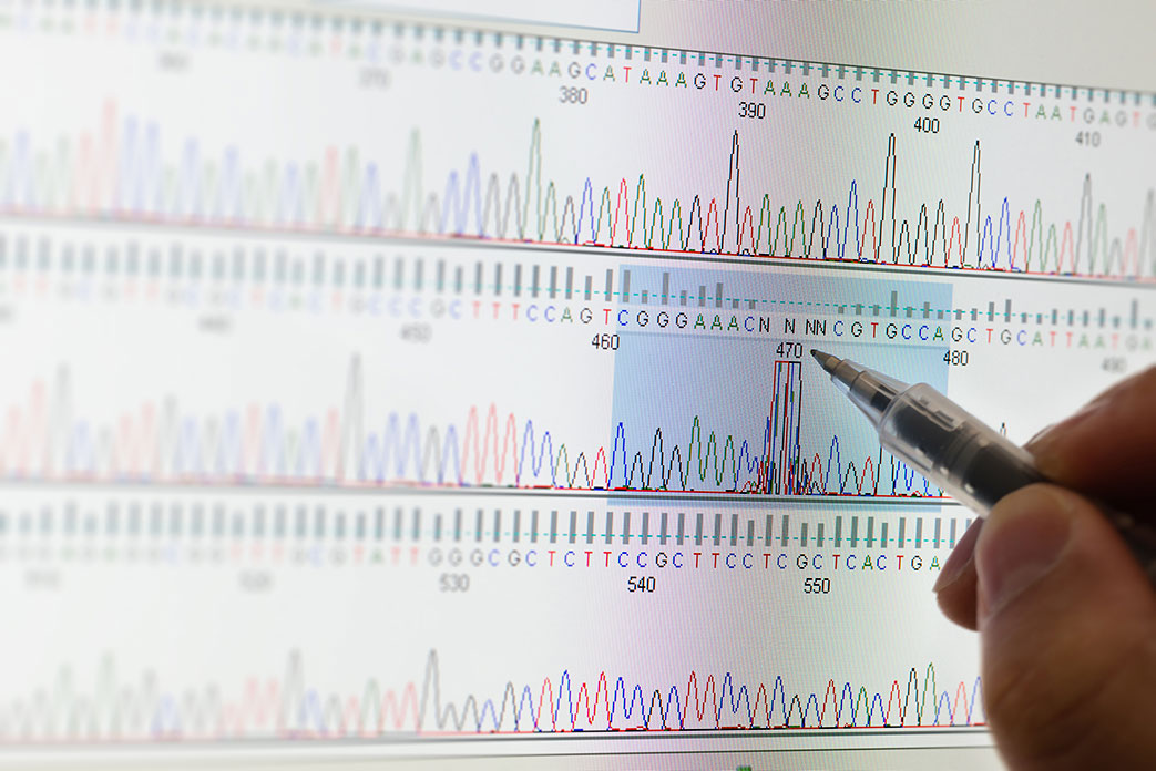 a ball point pen marking a chart of DNA sequencing in a scientific study.