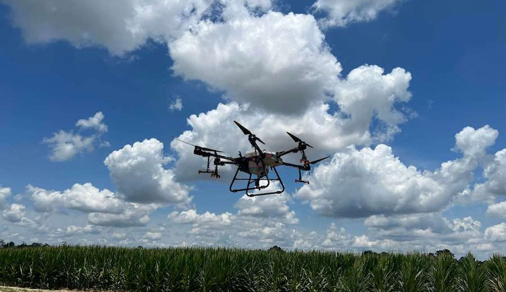 sprayer drone providing the targeted application over a crop field.